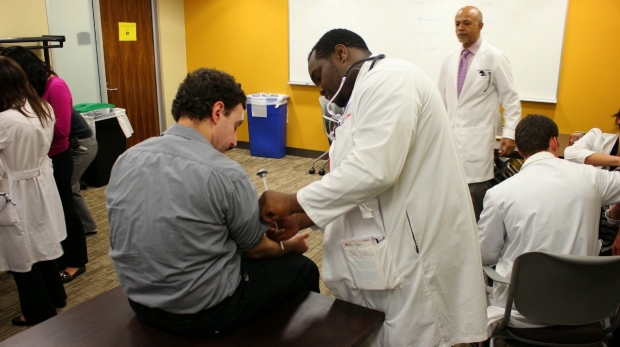 Physician demonstrates the reflex exam